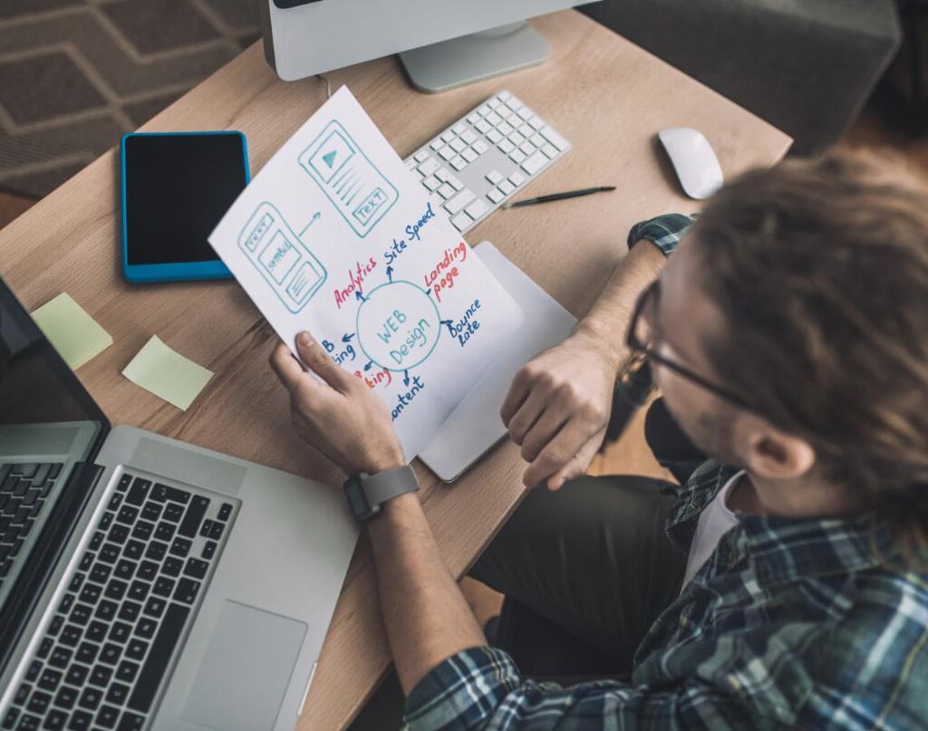 Man In Checkered Shirt Working In The Office R3BGYDR 1 1024x807